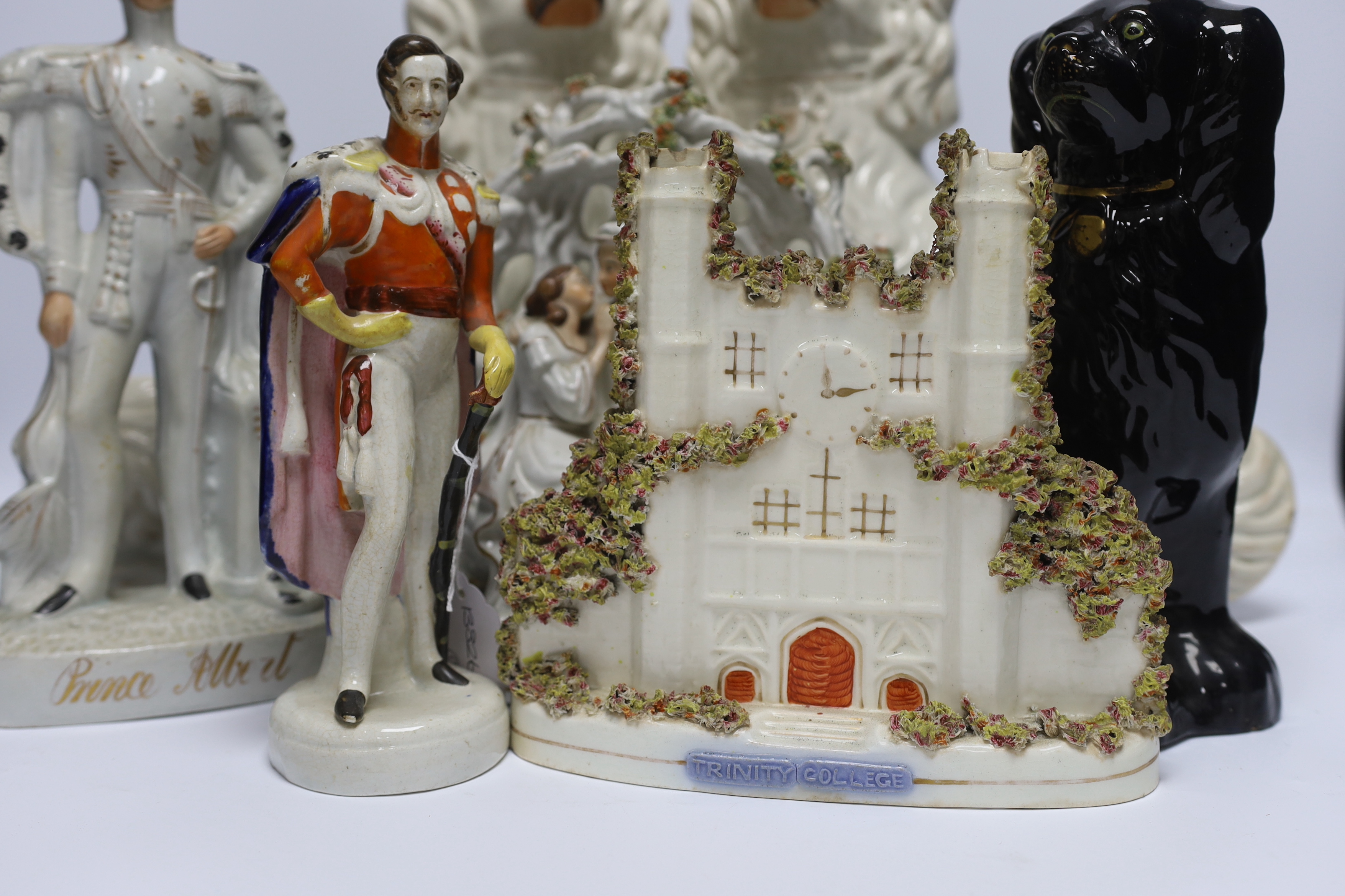 A mixed collection of Staffordshire figure groups to include various spaniels, Prince Albert figure, further courting couples and other bocage groups